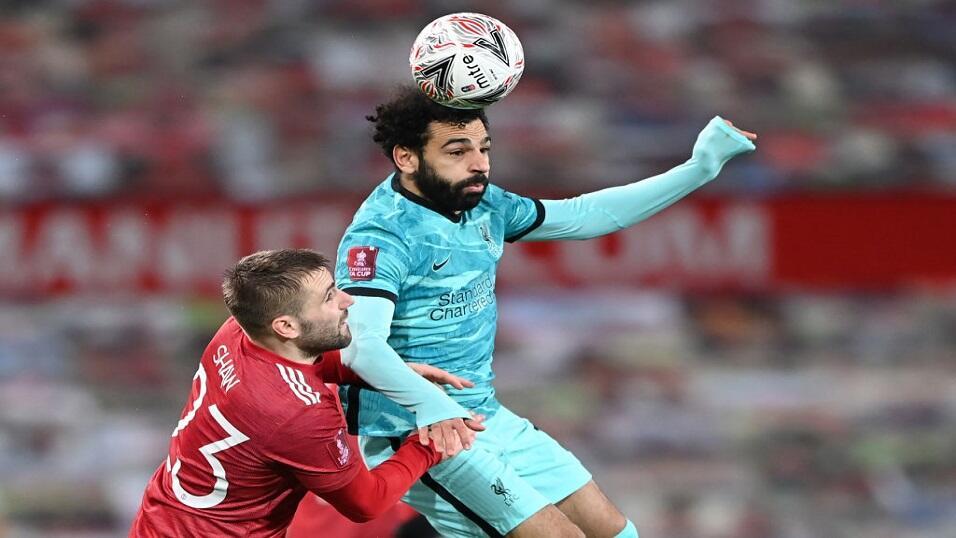 Harry Maguire and Mo Salah compete for the ball